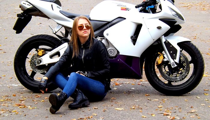Girl resting near motorbike