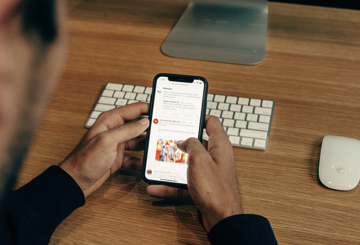 Man looking at bikes for sale on a phone