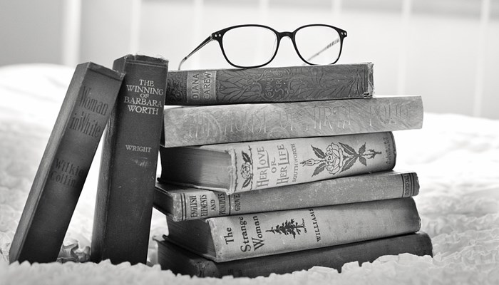 Pile of books with glasses on top